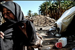 Bam , Iran<br><br>Woman in front of her distroyed home, she lost most of her family, in 12 seconds approx. 40.000 people lost their life.<br><br><br><br>One month after the earthquake, life is still on the edge for most people in the region, afraid as they are because of the reguly afterchocks, aid that is progressing slowly and the <br><br>huge amount of death makes people sceptic about the future.<br><br><br><br>
