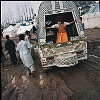 Pakistan, Kashmir  dec2005/febr2006<br>Muzafarrabad, at Ambur refugee camp an all dressed up family comes back from a ceremony, however the pickup the have borrowed gets stock in the mud.<br>Tha camp has a big problem with flies, since all city garbage is dumped in the river close by.<br><br>More than 70.000 people have lost their lives during the earthquake in the Pakistan Kashmir regions on October 8.<br>Cities like Balakot , near the epical center report close to 100% destroyed homes that are beyond rebuilding.<br>In the mountain regions of Kashmir, people are difficult to reach and some area's can only be accessed after spring arrives.<br>This creates a huge flood of people that flee the mountains during wintertime, facing the dangerous landslides,<br>to arrive in the hands of the Aid agencies who have a huge task, while some have lack of funding.<br>The fear of total isolation, outbreak of diseases, and traumatized victims is a  long task for the future.<br>In the tents, life tries to find it's rules again, the refugees  try to forget all they have lost and hope for a better future.<br>