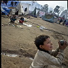 Pakistan, Kashmir  dec2005/febr2006<br>Muzafarrabad, the former sports field near the old university has been taken over by tents, by blocking the construction of new toilets the school boards forces the refugees to leave the area.<br><br>More than 70.000 people have lost their lives during the earthquake in the Pakistan Kashmir regions on October 8.<br>Cities like Balakot , near the epical center report close to 100% destroyed homes that are beyond rebuilding.<br>In the mountain regions of Kashmir, people are difficult to reach and some area's can only be accessed after spring arrives.<br>This creates a huge flood of people that flee the mountains during wintertime, facing the dangerous landslides,<br>to arrive in the hands of the Aid agencies who have a huge task, while some have lack of funding.<br>The fear of total isolation, outbreak of diseases, and traumatized victims is a  long task for the future.<br>In the tents, life tries to find it's rules again, the refugees  try to forget all they have lost and hope for a better future.<br>