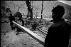 Pakistan, Kashmir  dec2005/febr2006<br>Klasha, tha man who ownes the saw makes good business, he vistes all villages to cut the wood for rebuilding.<br><br>More than 70.000 people have lost their lives during the earthquake in the Pakistan Kashmir regions on October 8.<br>Cities like Balakot , near the epical center report close to 100% destroyed homes that are beyond rebuilding.<br>In the mountain regions of Kashmir, people are difficult to reach and some area's can only be accessed after spring arrives.<br>This creates a huge flood of people that flee the mountains during wintertime, facing the dangerous landslides,<br>to arrive in the hands of the Aid agencies who have a huge task, while some have lack of funding.<br>The fear of total isolation, outbreak of diseases, and traumatized victims is a  long task for the future.<br>In the tents, life tries to find it's rules again, the refugees  try to forget all they have lost and hope for a better future.<br>