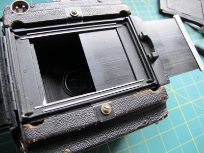 2 home made clamps holding the front side of the Graflex  Rollfilm holder